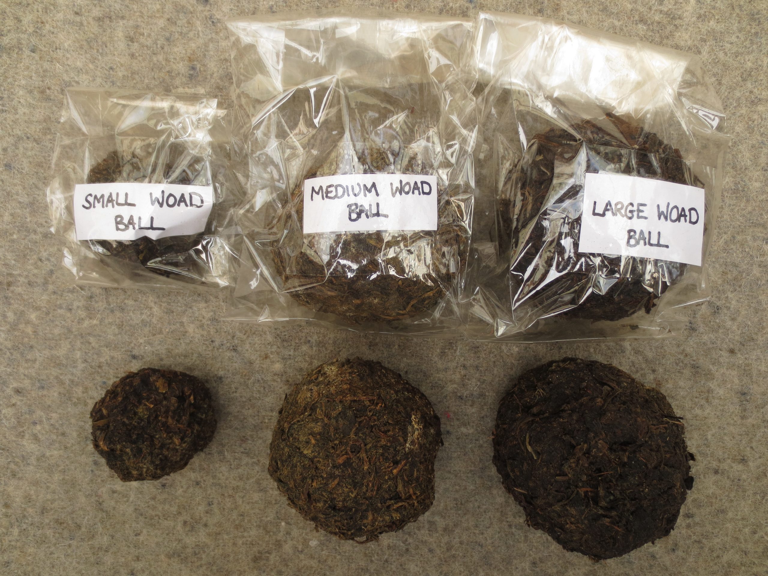 Photo of 3 different size Woad balls labelled small, medium and large