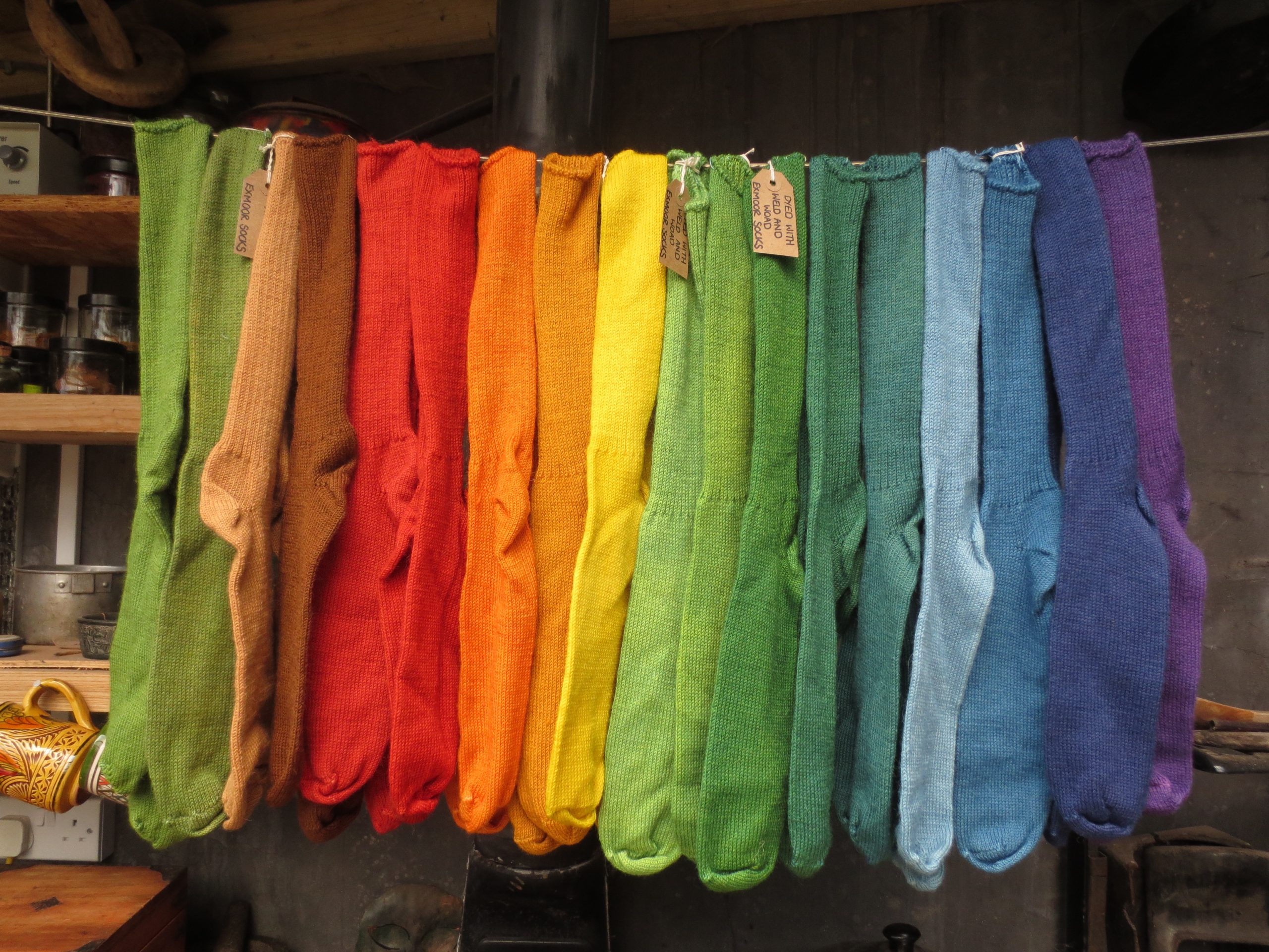 Selection of naturally dyed socks hanging on a line