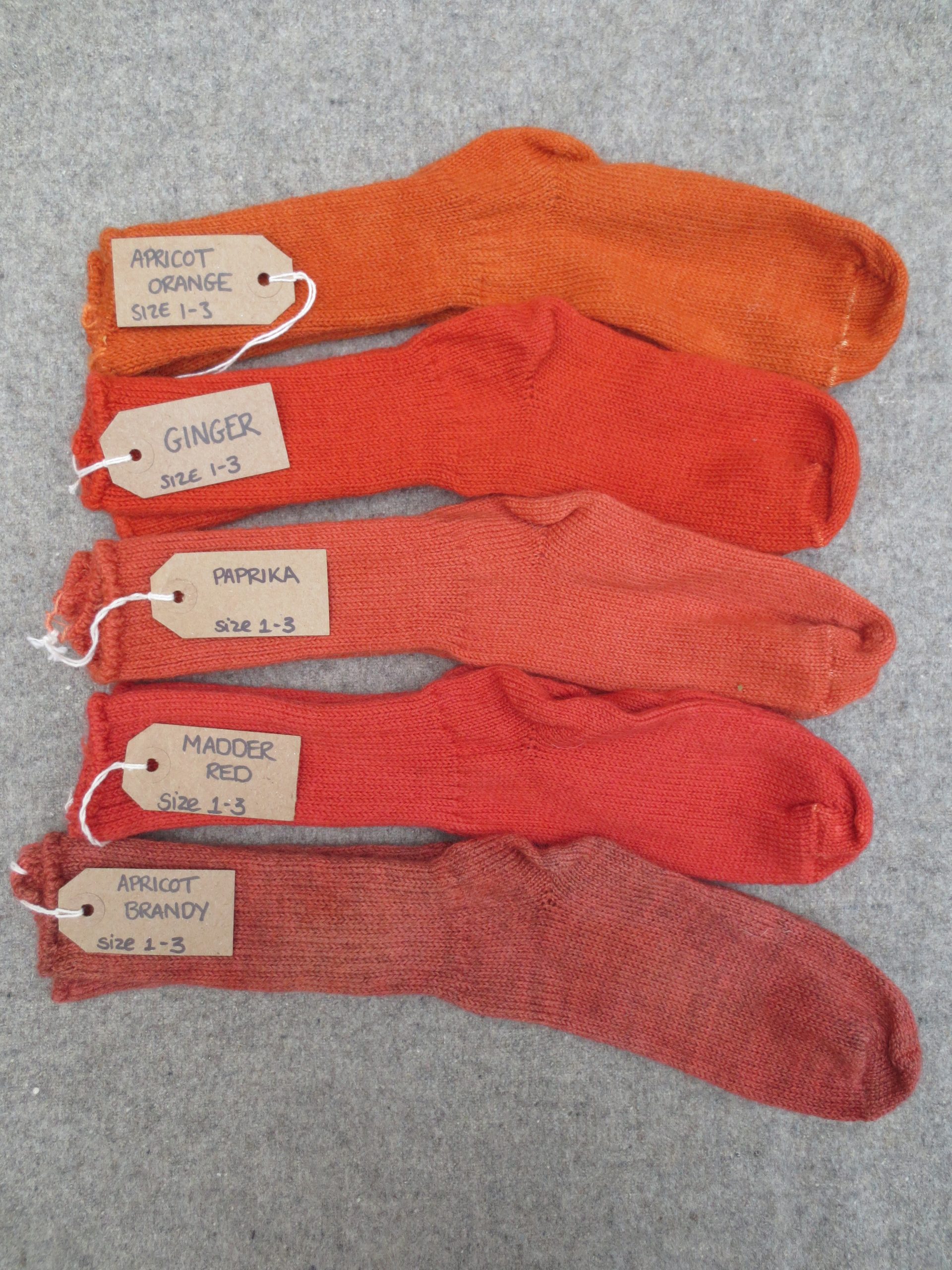 5 pairs of wool socks labelled apricot orange, ginger, paprika, madder red and apricot brandy