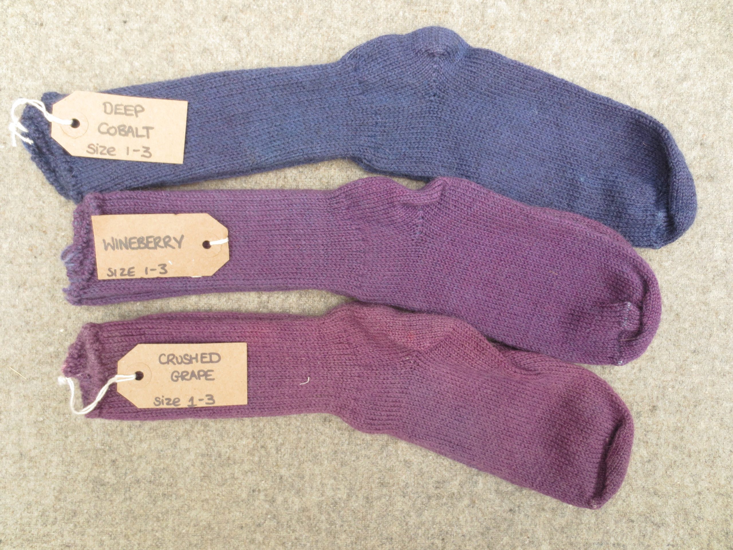 3 pairs of wool socks labelled deep cobalt, wineberry, crushed grape