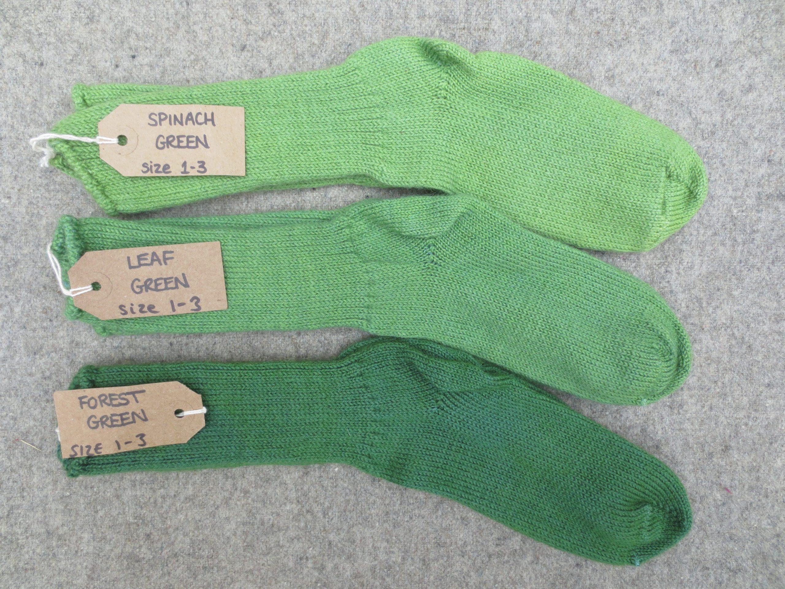 3 pairs of wool socks labelled spinach green, leaf green and forest green