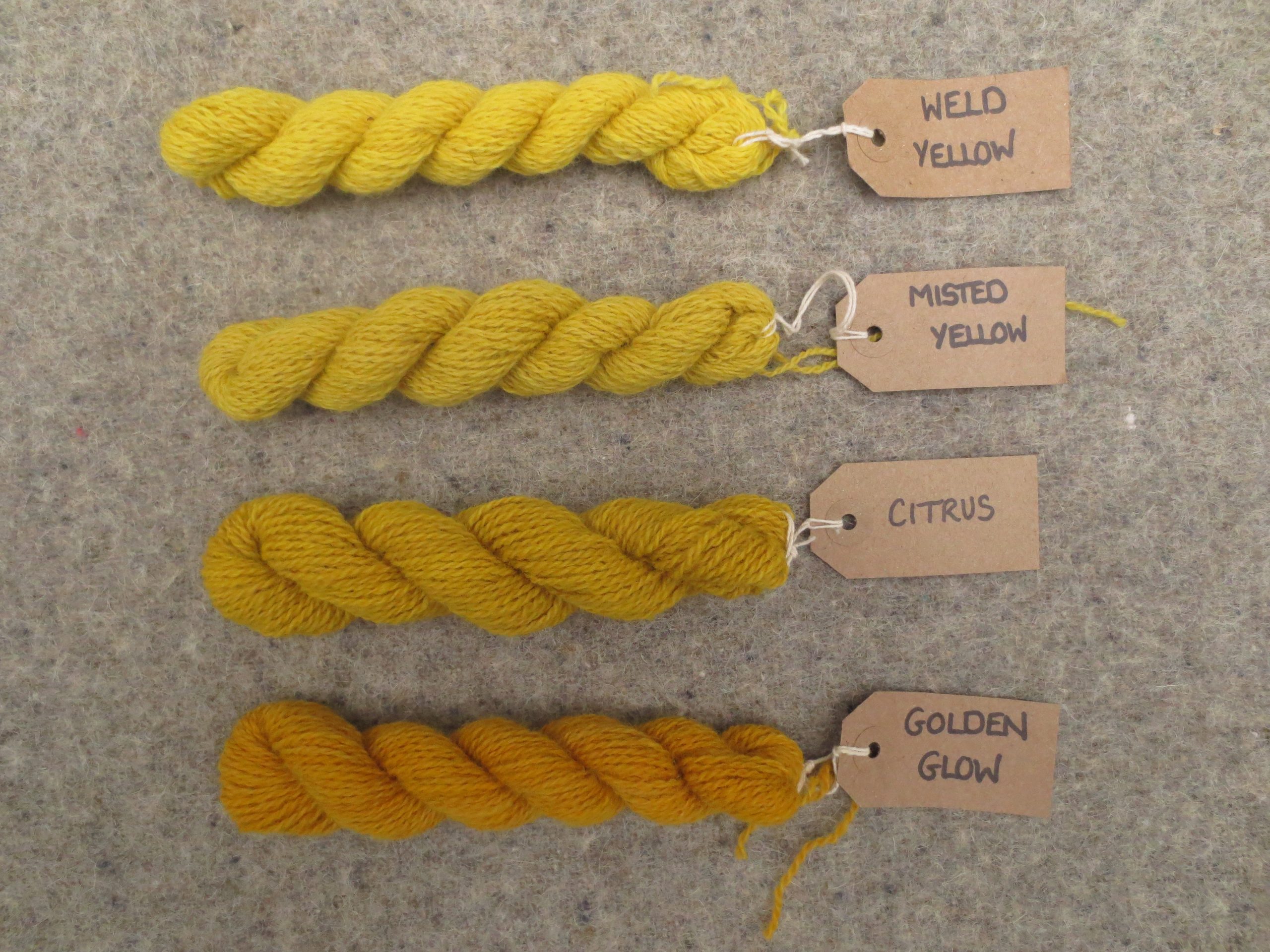 Tablet weaving wools labelled weld yellow, misted yellow, citrus and golden glow