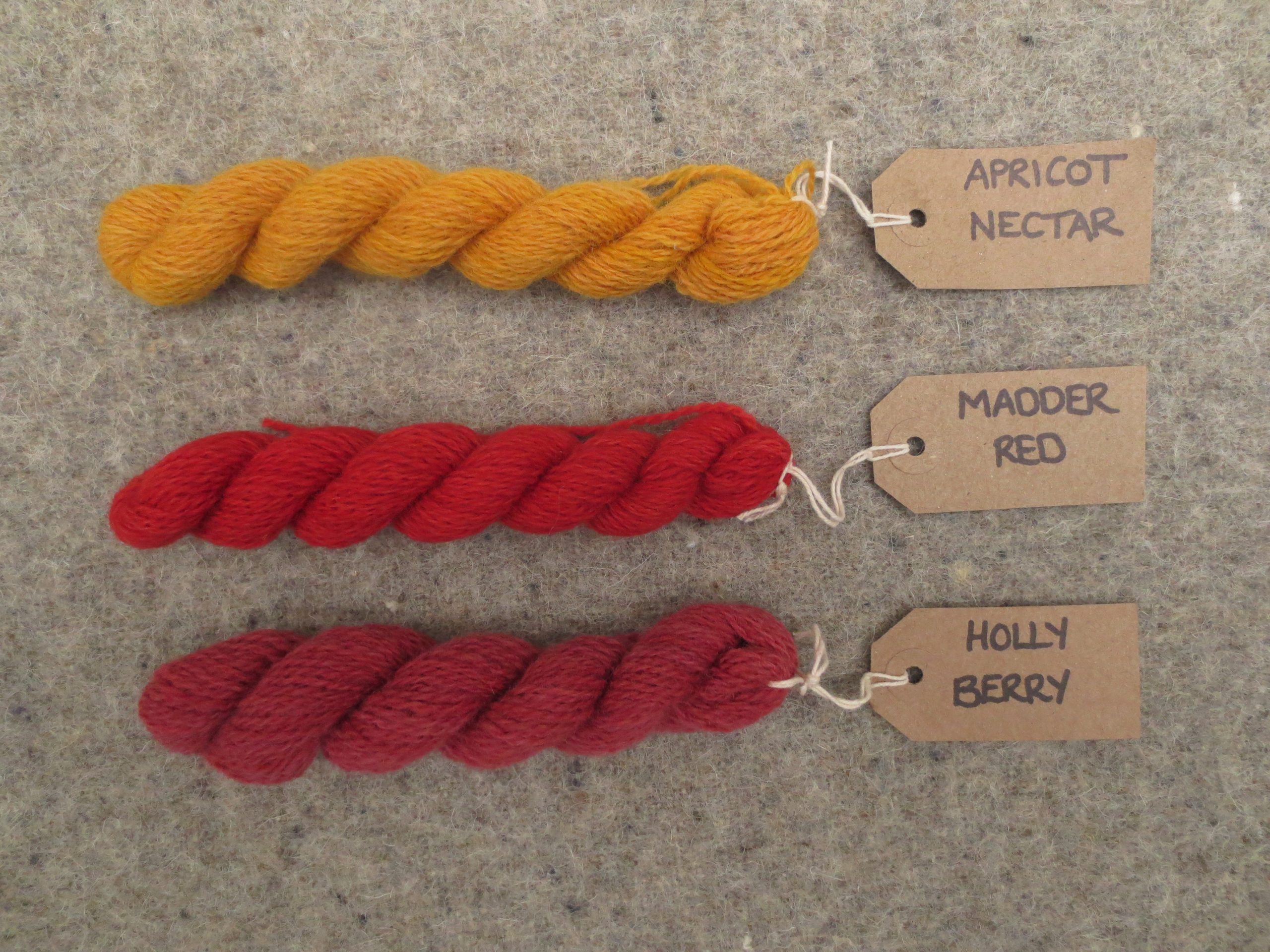 Tablet weaving wools labelled apricot nectar, madder red and holly berry