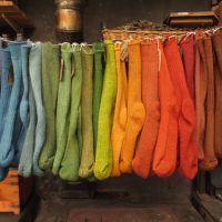 Earth Range of Size 4-7 Stanbury Walker socks hanging in front of Rayburn