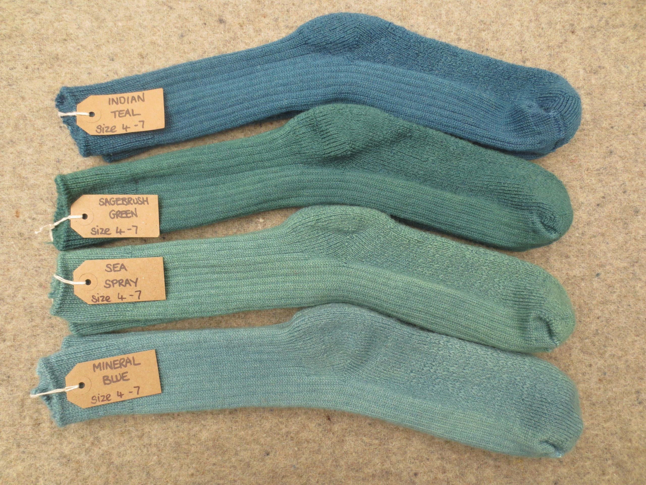 4 Pairs of walking socks labelled Indian Teal, Sagebrush Green, Sea Spray and Mineral Blue