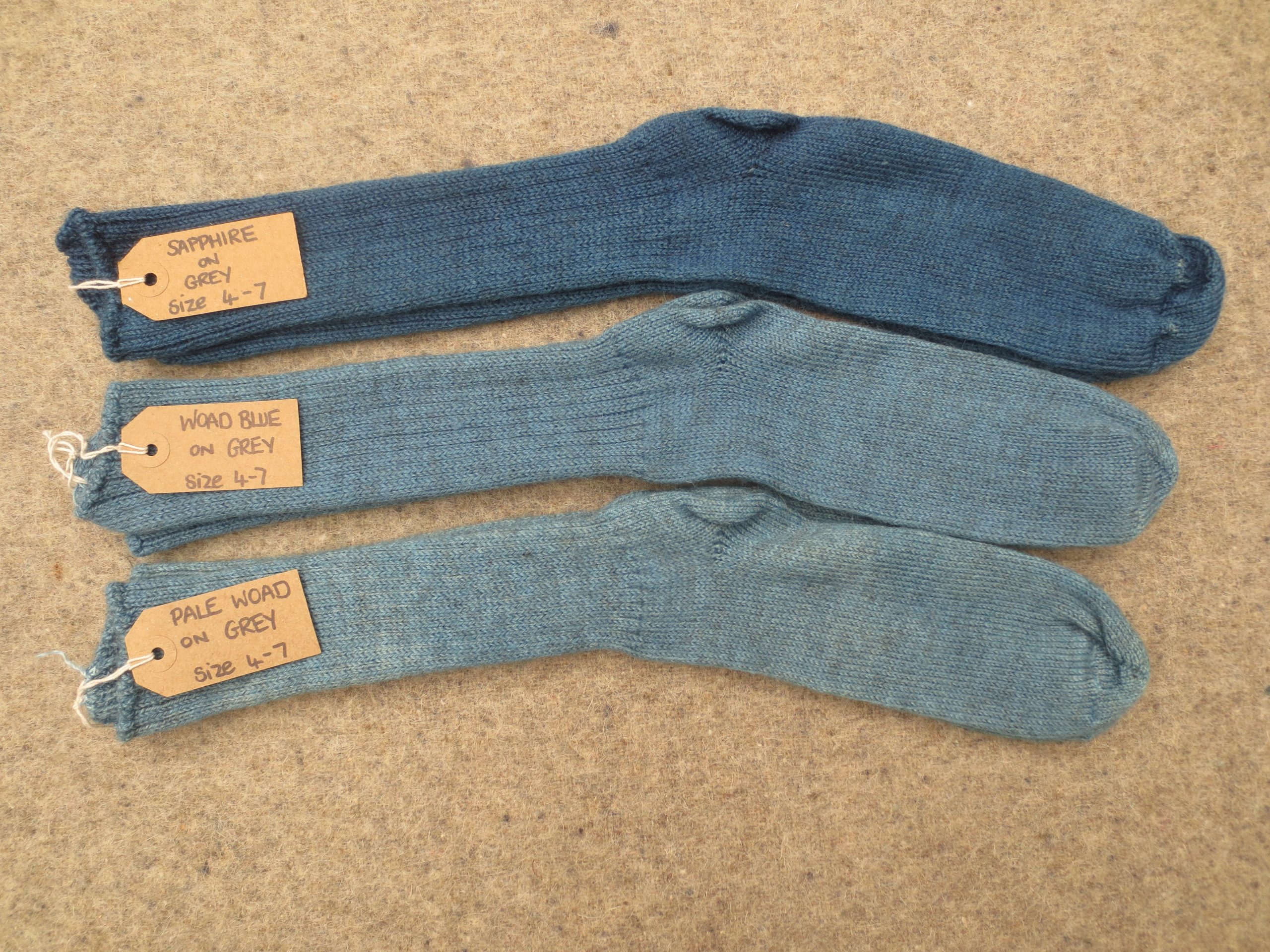 3 pairs of socks labelled sapphire on grey, woad on blue, pale woad on grey