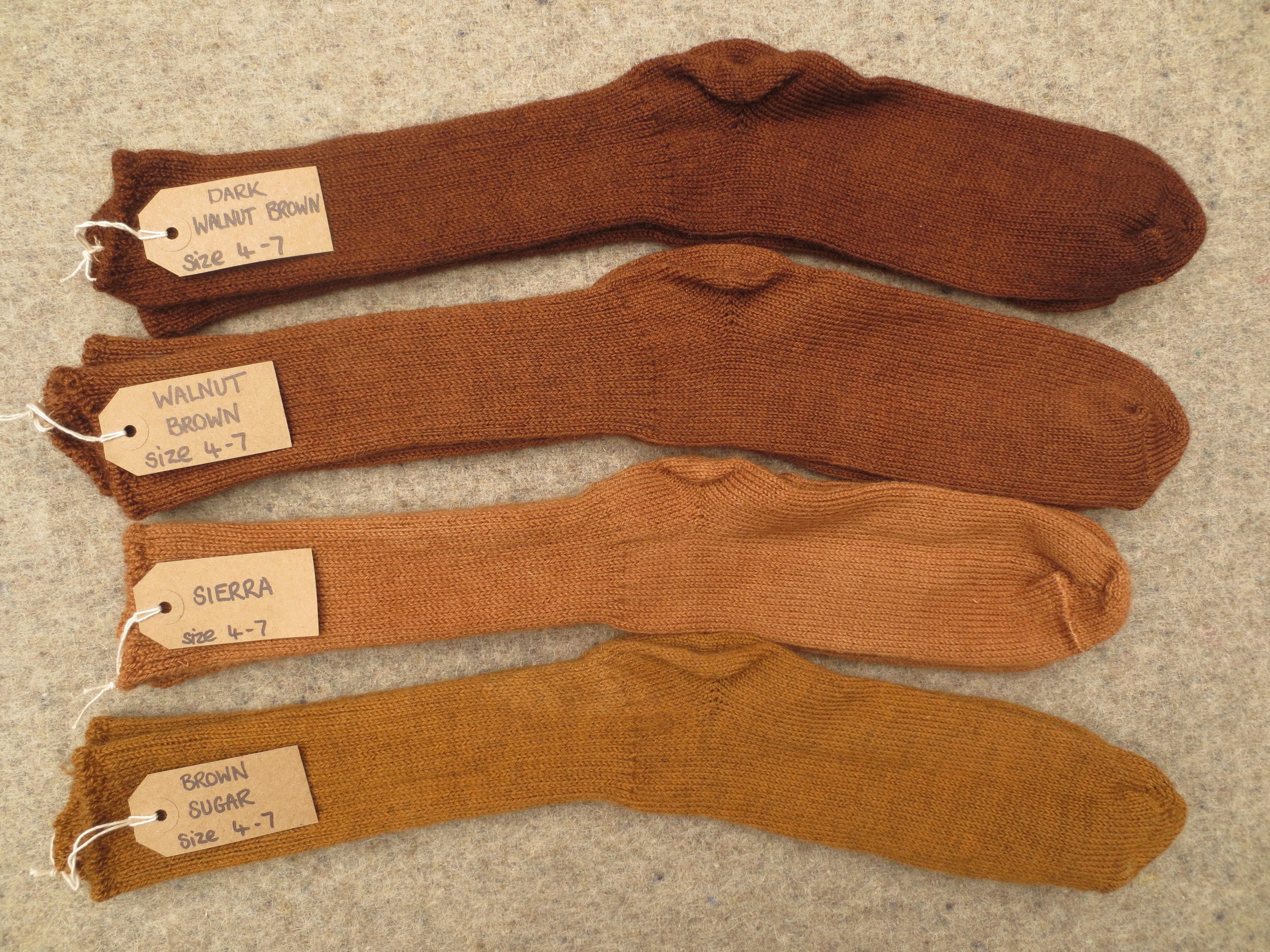 4 pairs of socks labelled dark walnut brown, walnut brown, sierra and brown sugar