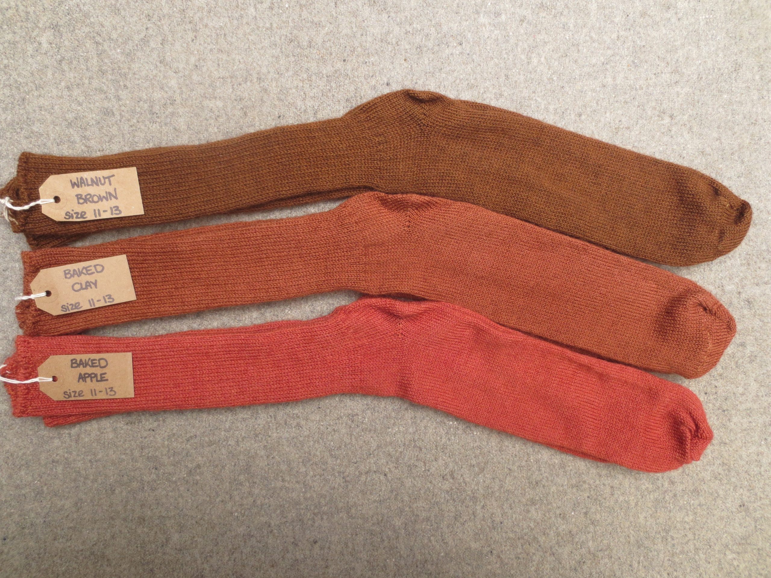 3 pairs of socks labelled Walnut Brown, Baked Clay and Baked Apple
