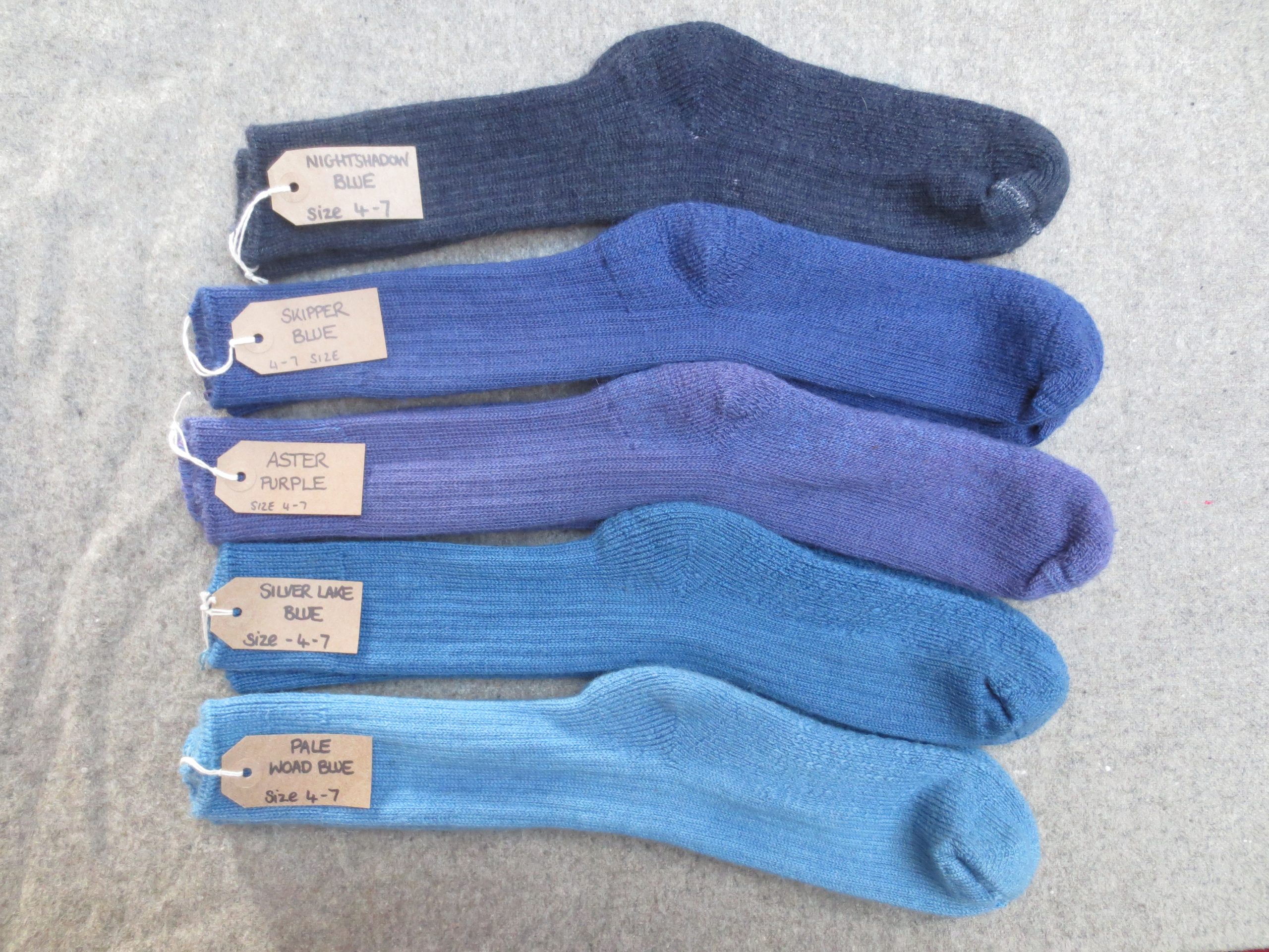 5 pairs of walking socks labelled Nightshadow Blue, Skipper Blue, Aster Purple, Silver Lake Blue and Pale Woad Blue