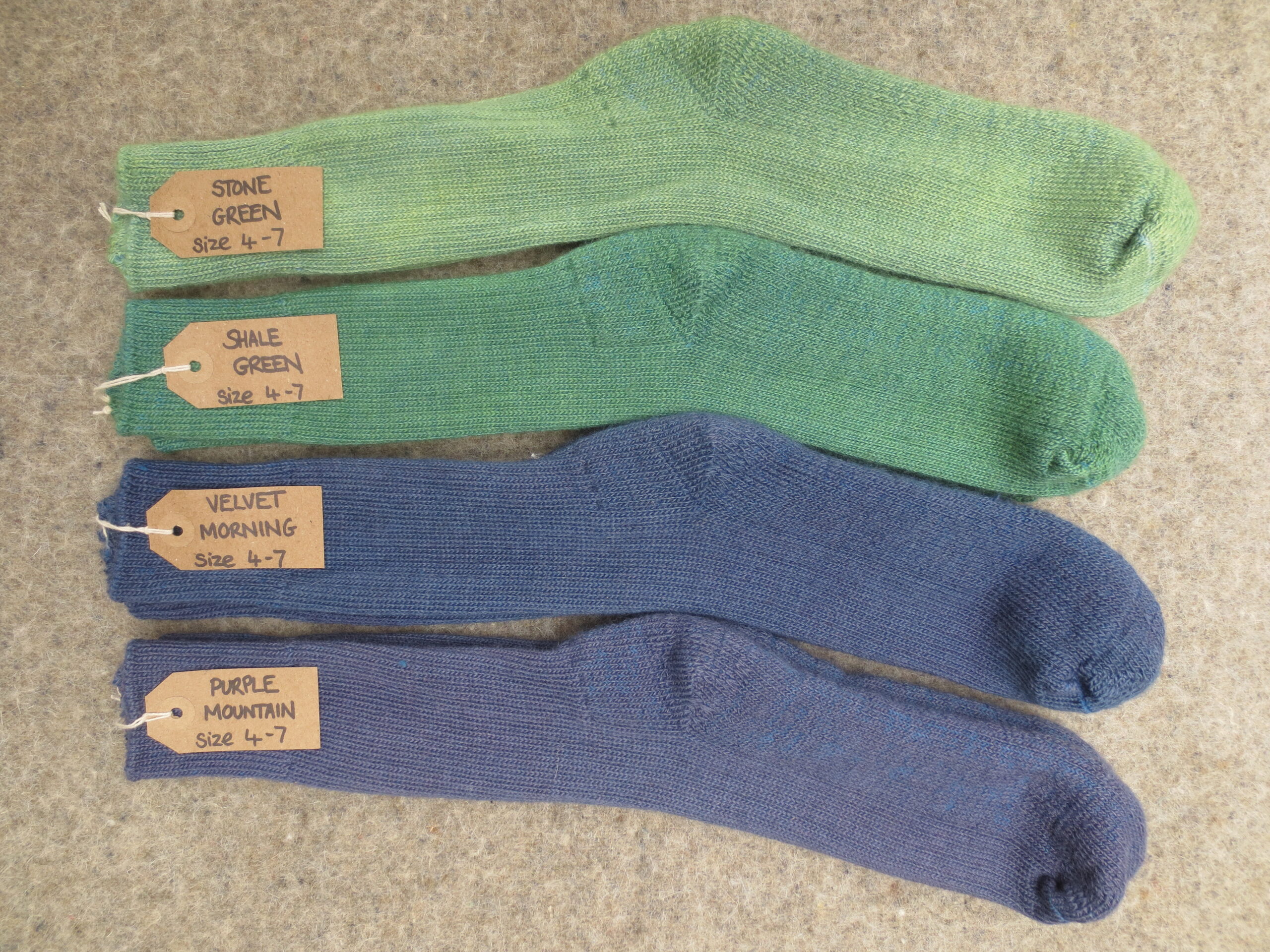 4 pairs of walking socks labelled Stone Green, Shale Green, Velvet Morning and Purple Mountain
