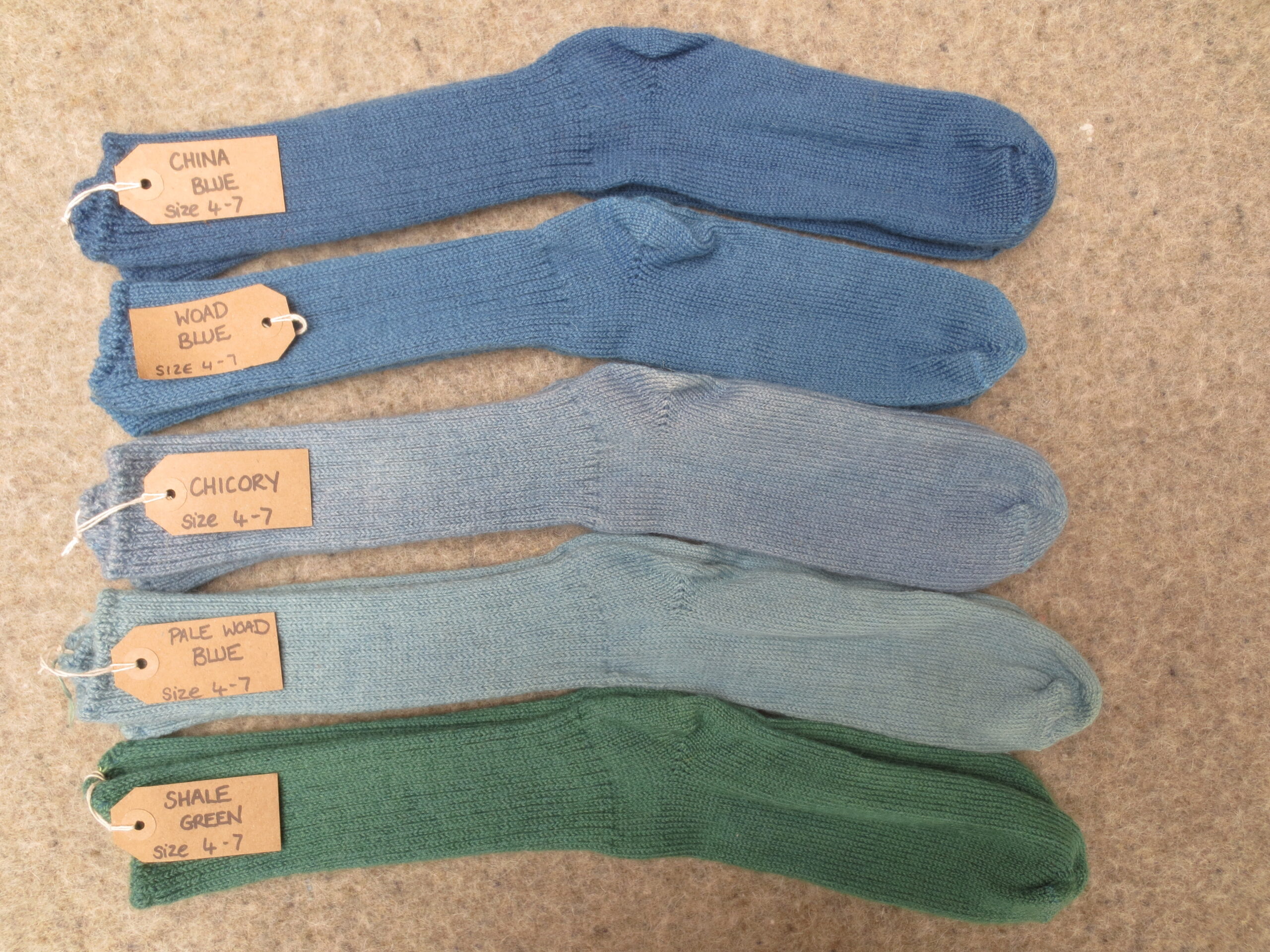 5 pairs of socks labelled China Blue, Woad Blue, Chicory, Pale Woad Blue and Shale Green